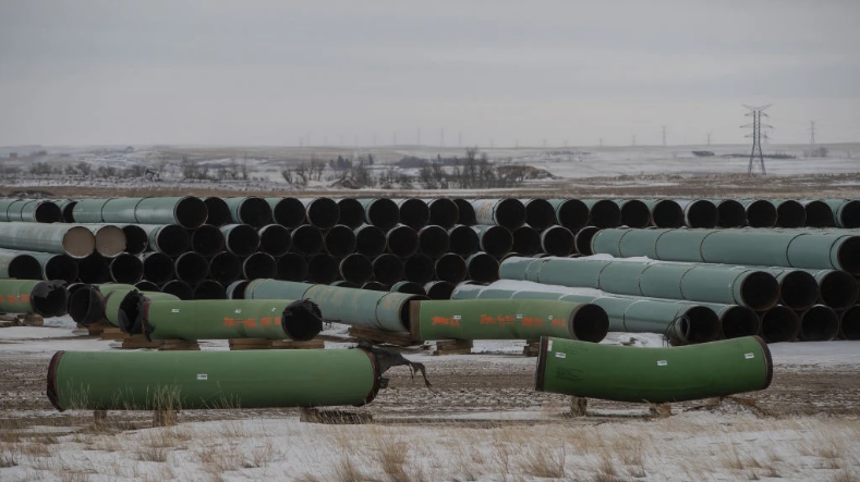 Pipes for the Keystone XL pipeline stacked in a yard near Oyen, Alberta, Canada, on Tuesday, Jan. 26, 2021. U.S. President Joe Biden revoked the permit for TC Energy Corp.'s Keystone XL energy pipeline via executive order hours after his inauguration.