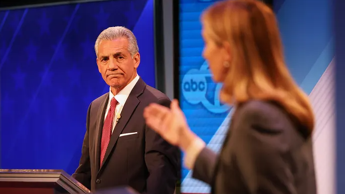 Republican Jack Ciattarelli, left, looks on while Democrat Mikie Sherrill speaks during the final debate in the New Jersey governor's race on Wednesday, Oct. 8, 2025, in New Brunswick, N.J.