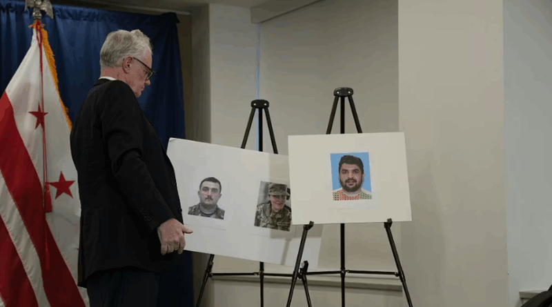 A staff member from the United States Attorney’s Office for the District of Columbia places a photo of the two wounded National Guard soldiers and the shooting suspect on a stand before a press conference on November 27, 2025, in Washington, DC.